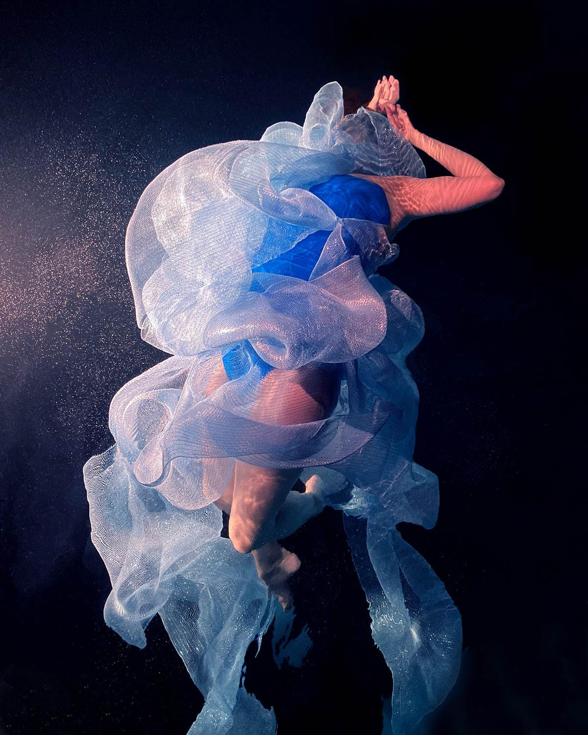 Swirling Fabrics Envelop Floating Subjects in Underwater Photographs by Christy Lee Rogers