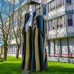 A statue of Prince Philip in academic robes in Cambridge, United Kingdom.