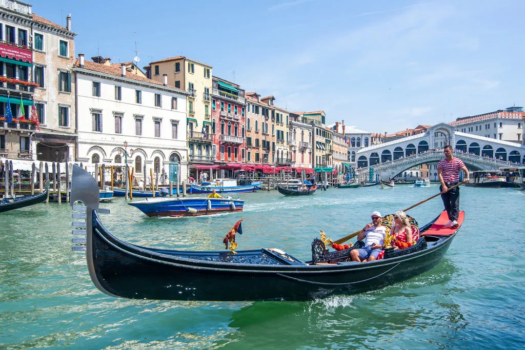 VENICE, ITALY - JUNE 12: Tourists enjoy a gondola ride on June 12, 2021 in Venice, Italy. International tourists started to travel again after the Covid-19 pandemic, as more people are now inoculated against the virus. (Photo by Luca Zanon/Awakening/Getty Images)