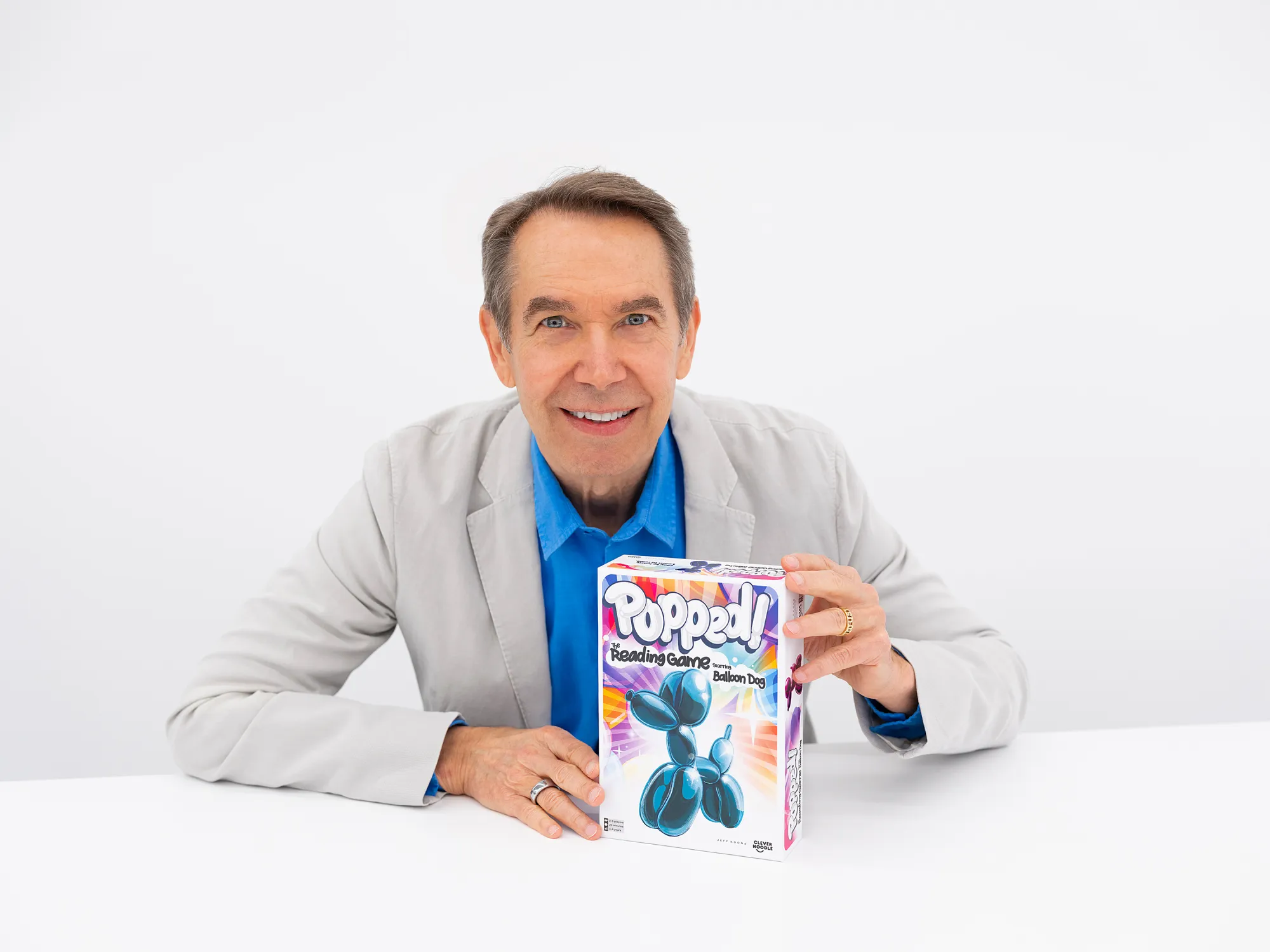 The artist Jeff Koons holds  box for new game 
