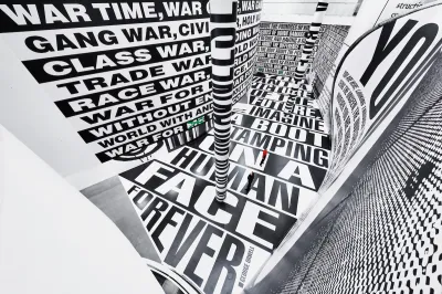 A tiny man in a space whose walls and floor are covered in text.