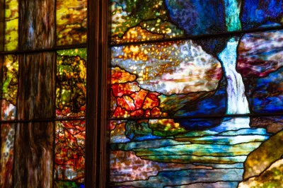 A detailed view of a stained glass window showing various colors and textures.