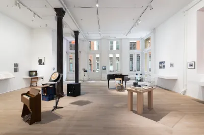 A gallery filled with pianos and vitrines.