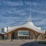 A museum whose roof is white and wavy.