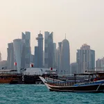 Traditional dhow boats are anchored in front of the Doha skyline on July 5, 2025. (Photo by Karim JAAFAR / AFP) (Photo by KARIM JAAFAR/AFP via Getty Images)