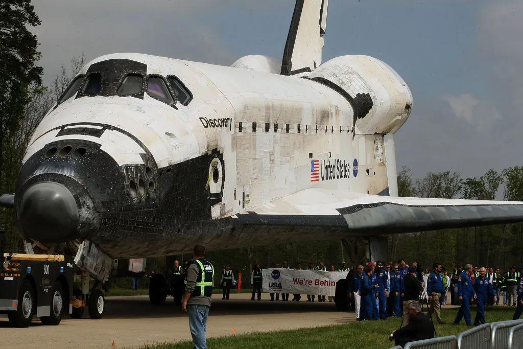 CHANTILLY, VA - APRIL 19: The Space Shuttle Discovery is towed up to an event at the Smithsonian National Air and Space Museum Steven F. Udvar-Hazy Center April 19, 2012 in Chantilly, Virginia. The space shuttle Discovery is the he oldest and most traveled vehicle from NASA