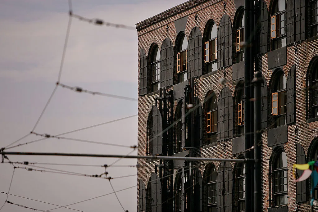 NEW YORK - JUNE 15: Old trolley cables grace the area in front of a 19th century warehouse, now used as apartments, on the waterfront June 15, 2007, in the Red Hook section of Brooklyn, New York. The National Trust for Historic Preservation plans to declare Brooklyn