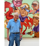 An older man with glasses smiles at the camera. Behind him is a pretty crazy painting of four similarly bespectacled men, one of whose eyes is popping out of his gourd.