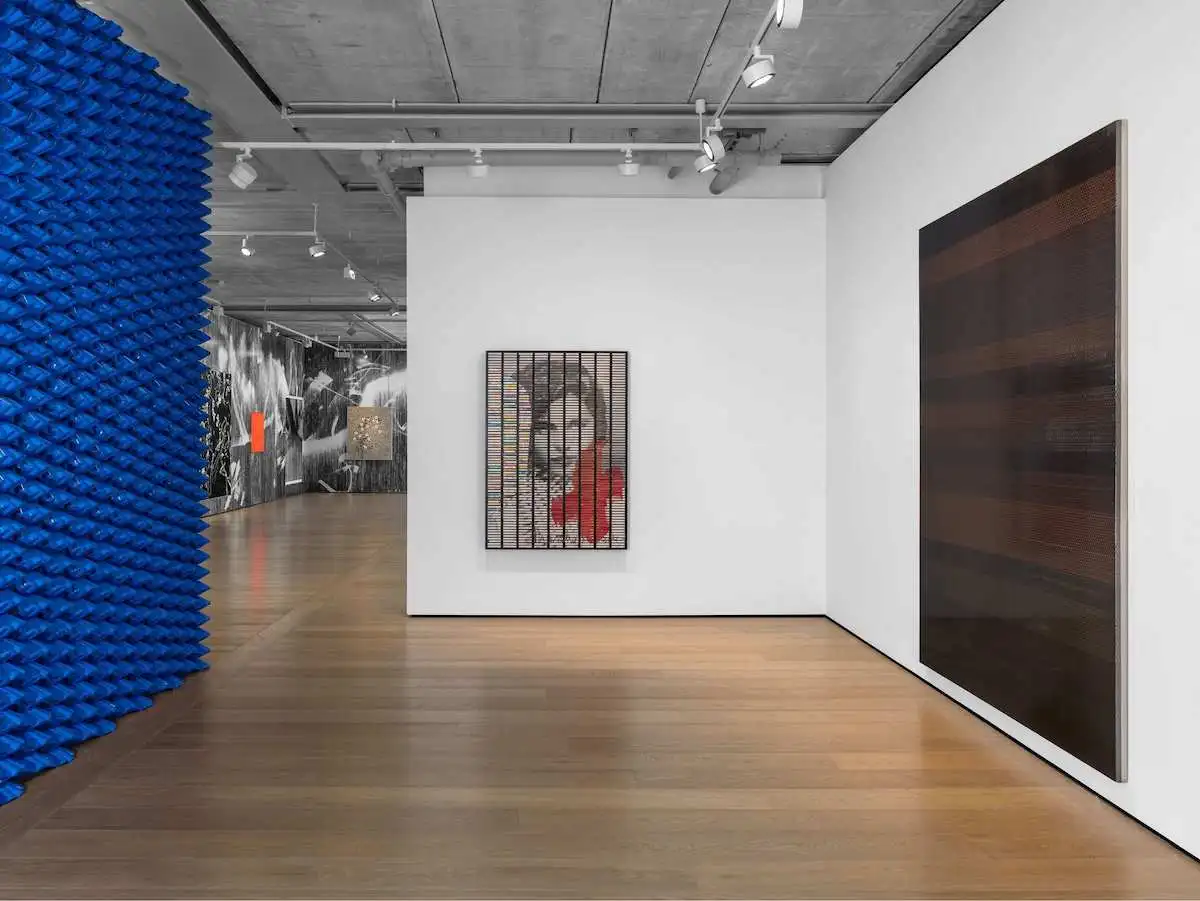 A gallery with paintings in it.