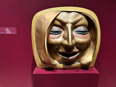 A fiberglass sculpture of a large head of a blonde woman. 