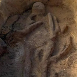 An ashen body in a pit.