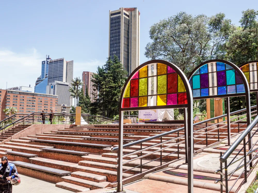 Some steps and stained glass installations against a city scape.