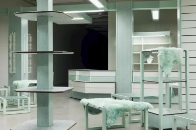 An empty shop interior with some shelves covered in blue-tinged furs.