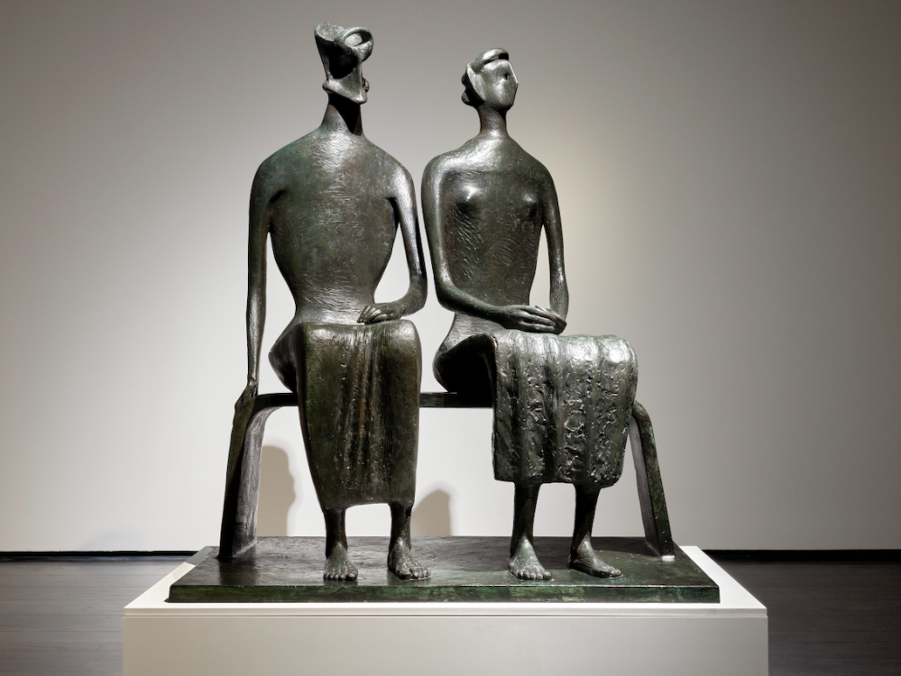 A bronze sculpture of two people.