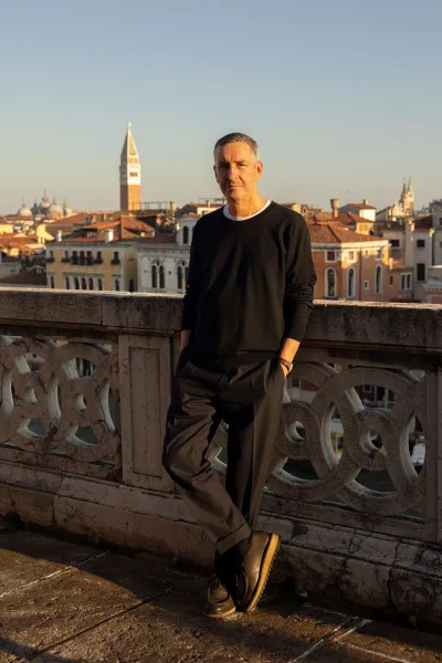 Portrait of Dries Van Noten, with Venice seen in the background. 