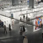 Aerial view of an art fair in a convention center.