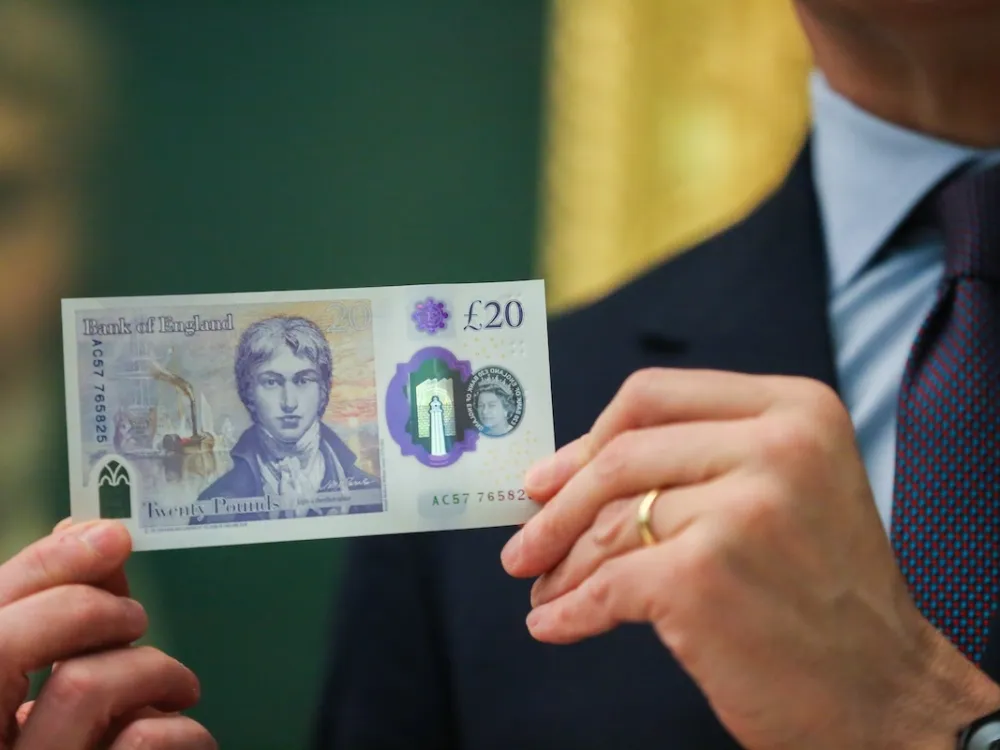 Governor of Bank of England Mark Carney holds the new Â£20 bank note featuring the artist JMW Turner, in front of his self-portrait at Tate Britain in London, United Kingdom on February 20, 2020. A portrait of JMW Turner features on the new Â£20 banknote which enters circulation on 20 February. (Photo by Dinendra Haria/Anadolu Agency via Getty Images)