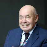 A smiling bald man.