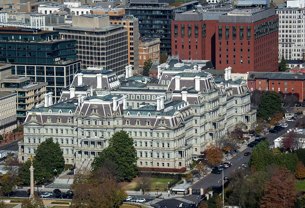 A arial view of a massive office  building complex, surrounded by trees and other buildings,  in Washington DC.