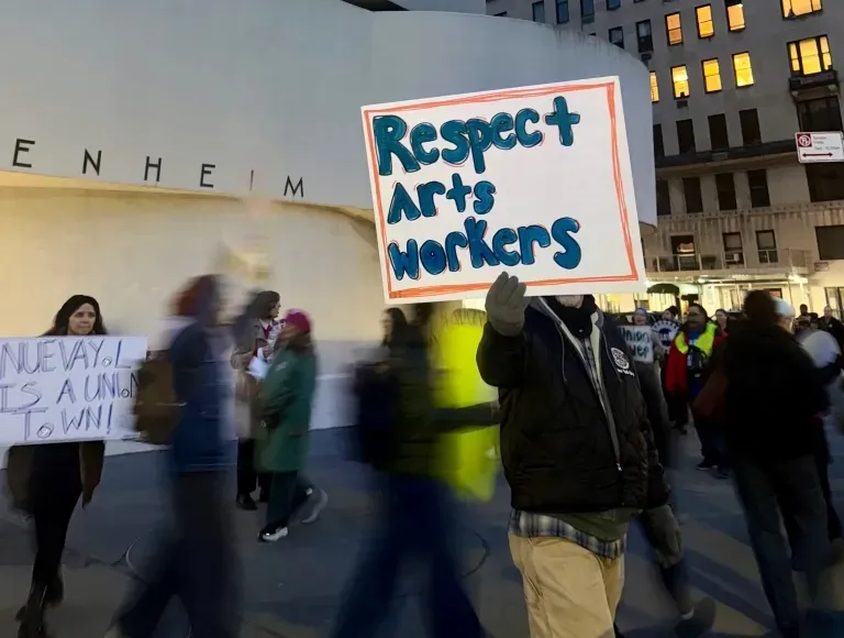 A person holding a sign reading 