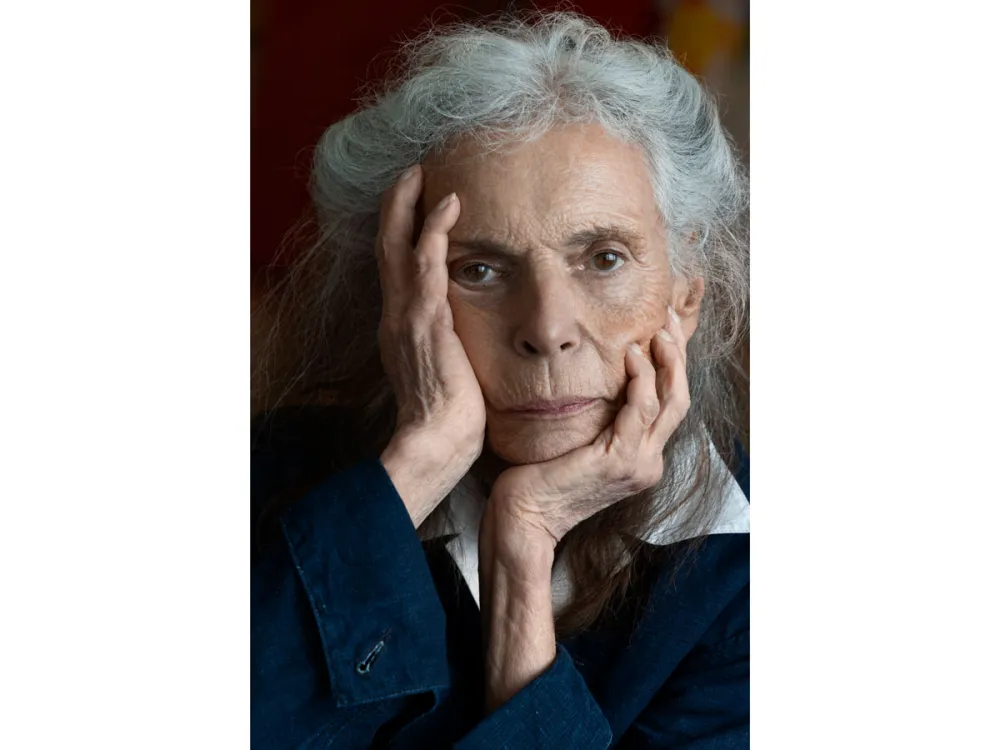 Close-up of portrait of Pat Steir, with her head in her hands.