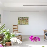 A minimalist living room with flowers and abstract.