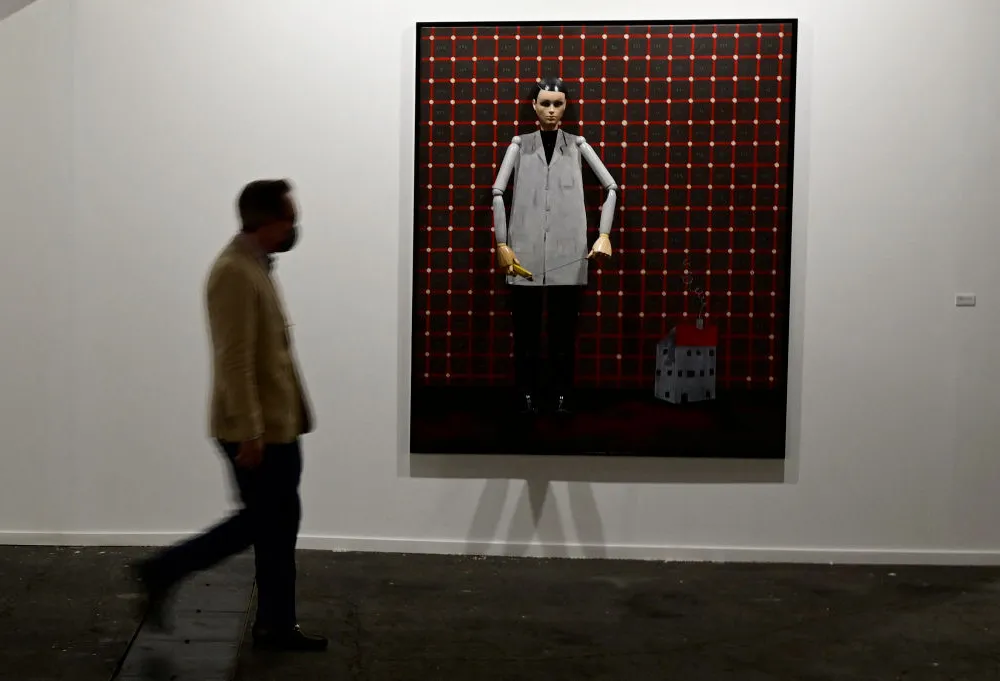 A visitor walks past an artwork by German artist Thomas Zipp  at the International Contemporary Art Fair 