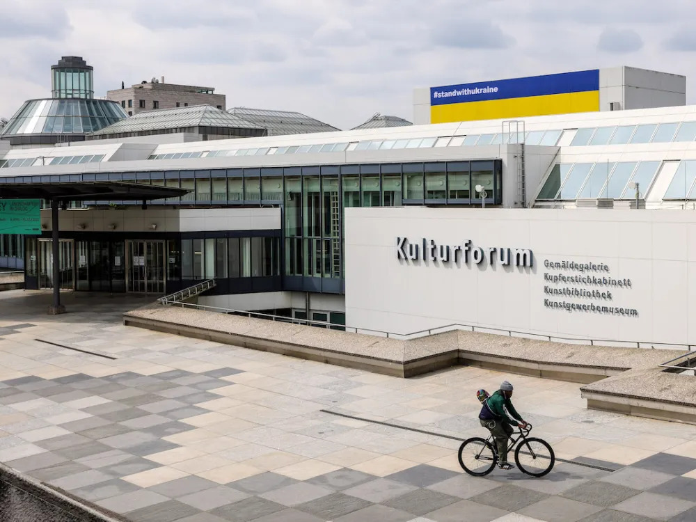 An imposing grey concrete and glass facade of a building.