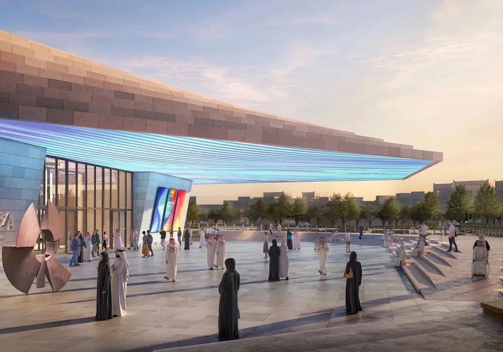 People standing beneath a roof in an outdoor sunken atrium.