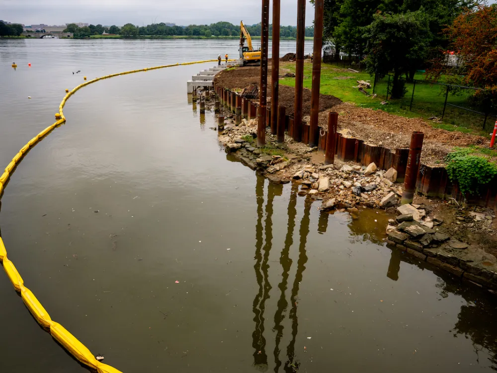 A construction site along a river bank.