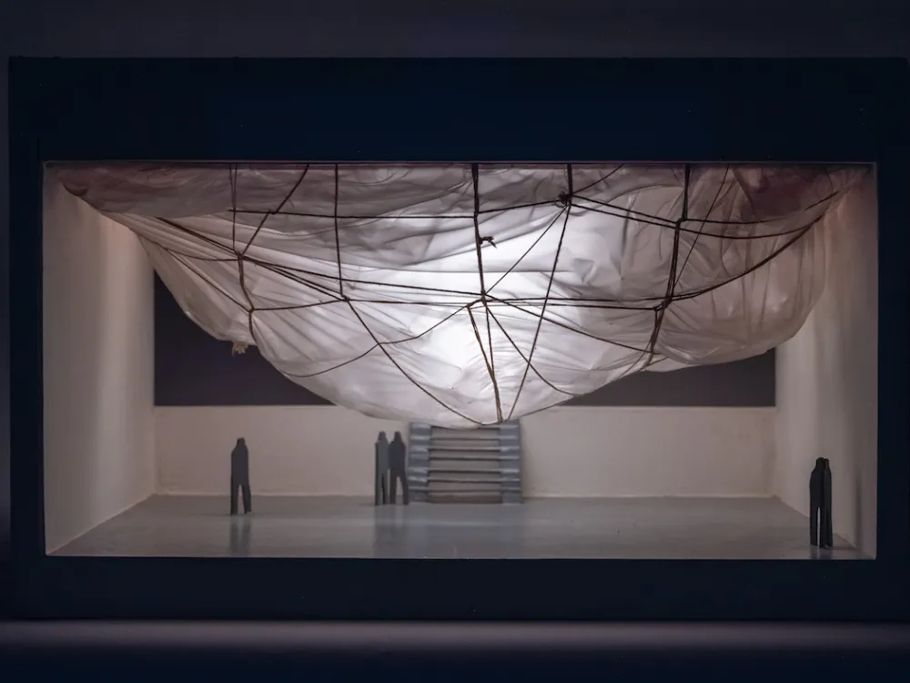 A maquette of a cloud-like form hanging from a ceiling.
