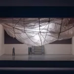 A maquette of a cloud-like form hanging from a ceiling.