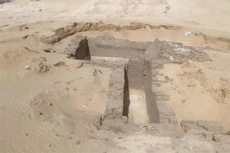 Stone ruins buried beneath sand.