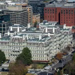 A arial view of a massive office  building complex, surrounded by trees and other buildings,  in Washington DC.