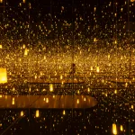 A reflective room with floating golden lights.