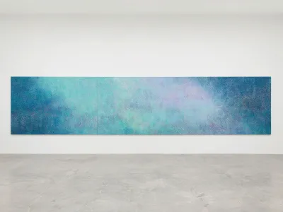 Installation view of a three-panel, 8-meter long abstract blue painting. 