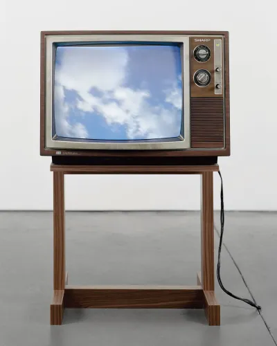 An old-school TV displaying an image of the sky.